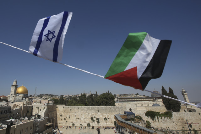 Palestinian and Israeli flags overlook Dome of Rock and Western Wall (credit: MARC ISRAEL SELLEM/THE JERUSALEM POST)