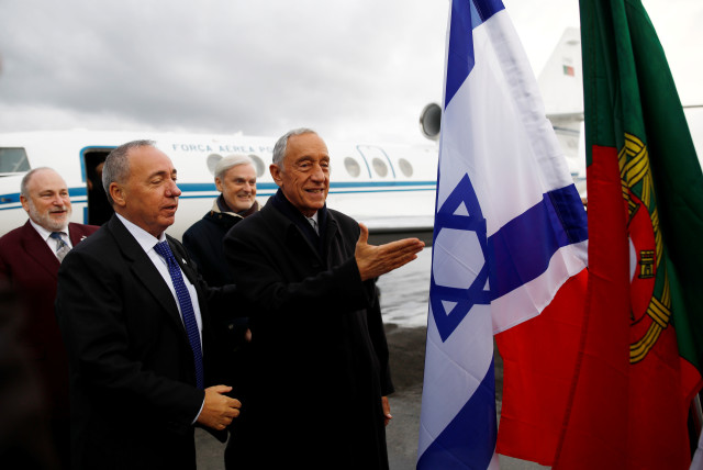 Portugal's President Marcelo Rebelo de Sousa gestures near national flags of Israel and Portugal upon landing at Ben Gurion International Airport to take part in a Yad Vashem Holocaust memorial event (credit: CORINNA KERN/REUTERS)