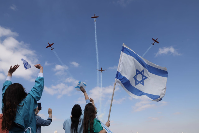 Medical staff at Jerusalem’s Shaare Zedek Medical Center wave at an Israel Air Force flyover on Independence Day (credit: MARC ISRAEL SELLEM)