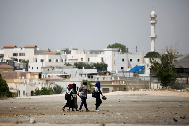 Girls walk on the outskirts of the Bedouin city of Rahat, southern Israel (credit: REUTERS/AMIR COHEN)