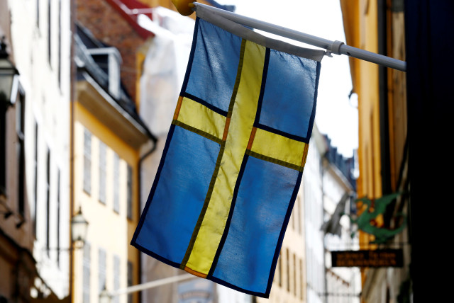 The Swedish flag is seen at Gamla Stan, the Old City of Stockholm, Sweden, May 7, 2017. (credit: INTS KALNINS / REUTERS)