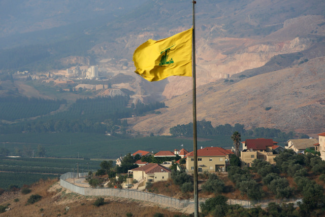 A Hezbollah flag flutters in the southern Lebanese village of Khiam, near the border with Israel, Lebanon July 28, 2020 (credit: REUTERS/AZIZ TAHER)