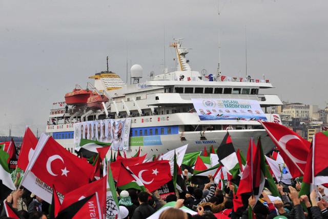 PRO-PALESTINIAN activists wave Turkish and Palestinian flags during the welcoming ceremony for the ‘Mavi Marmara,’ in Istanbul in December 2010. Nine Turkish activists died the previous May when IDF naval commandos stopped the ship. (credit: STRINGER/ REUTERS)