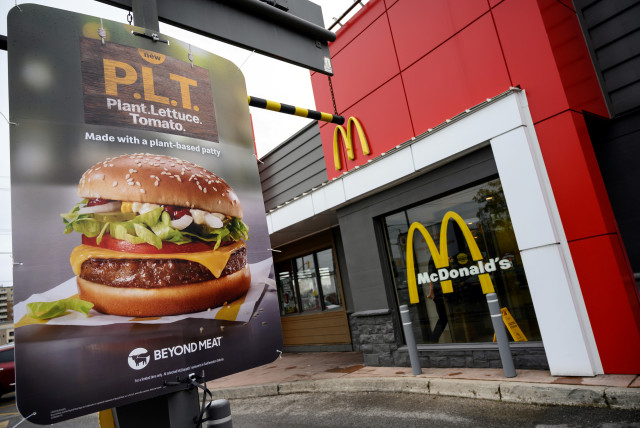 A sign promoting McDonald's ''PLT'' burger with a Beyond Meat plant-based patty at one of 28 test restaurant locations in London, Ontario (credit: REUTERS)