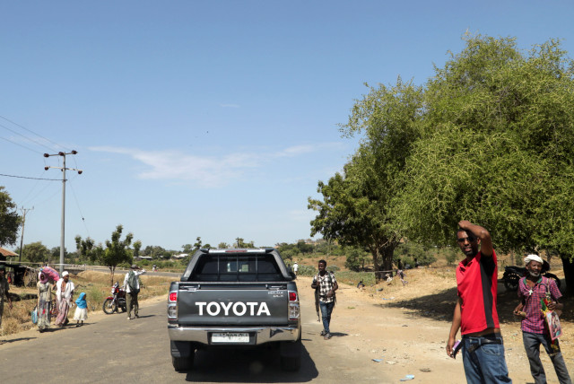 Members of Amhara militia control a motor vehicle checkpoint at the entrance of Dansha town in Tigray Region (credit: REUTERS)