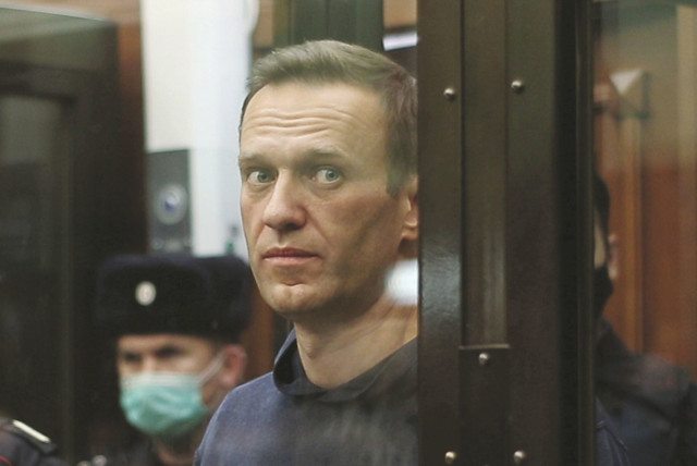 RUSSIAN OPPOSITION leader Alexei Navalny, who is accused of flouting the terms of a suspended sentence for embezzlement, inside a defendant dock during the announcement of a court verdict in Moscow, Russia earlier this month. (credit: REUTERS)