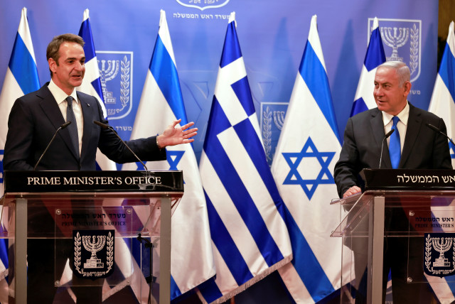 Greek Prime Minister Kyriakos Mitsotakis speaks next to the Israeli Prime Minister Benjamin Netanyahu after their meeting in the PM's office in Jerusalem February 8, 2021. (credit: MENAHEM KAHANA/POOL VIA REUTERS)
