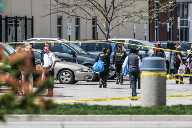 Investigators are on the scene following a mass shooting at a FedEx facility in Indianapolis, Indiana, U.S., April 16, 2021. (credit: MICHELLE PEMBERTON-USA TODAY NETWORK VIA REUTERS)
