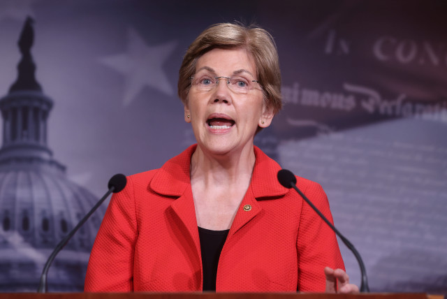 US Senator Elizabeth Warren (D-MA) speaks to reporters during a news conference on Democrats' demand for an extension of eviction protections in the next coronavirus disease (COVID-19) aid bill on Capitol Hill in Washington. (credit: REUTERS / JONATHAN ERNST)