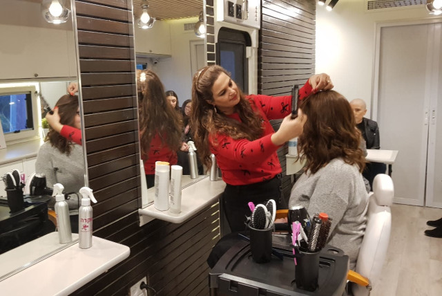 A woman getting her hair cut for donation in the ''Braid of Strength'' campaign (credit: ZICHRON MENACHEM PR)