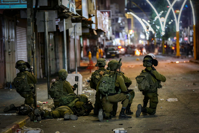 Clashes between the Israeli army and Palestinians in the West Bank city of Hebron on May 12, 2021. (photo credit: WISAM HASHLAMOUN/FLASH90)