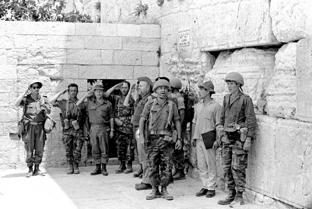 IDF SOLDIERS stand at the Western Wall in June 1967 after it was captured during the Six Day War. (credit: DEFENSE MINISTRY/REUTERS)