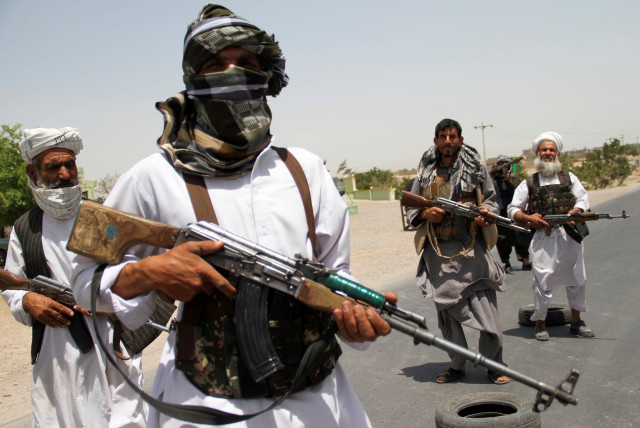 Former Mujahideen hold weapons to support Afghan forces in their fight against Taliban, on the outskirts of Herat province, Afghanistan July 10, 2021. (credit: JALIL AHMAD/REUTERS)