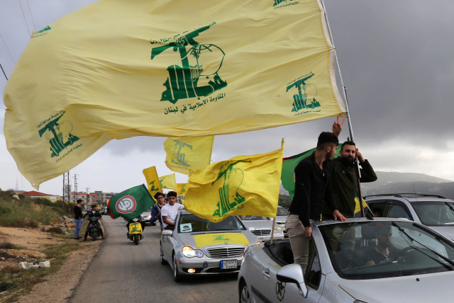 WAVING THE Hezbollah flag in Marjayoun, Lebanon. (credit: AZIZ TAHER/REUTERS)