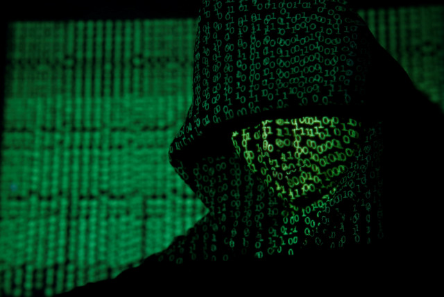Projection of cyber code on hooded man (llustrative) (credit: REUTERS/KACPER PEMPEL/ILLUSTRATION TPX IMAGES OF THE DAY)