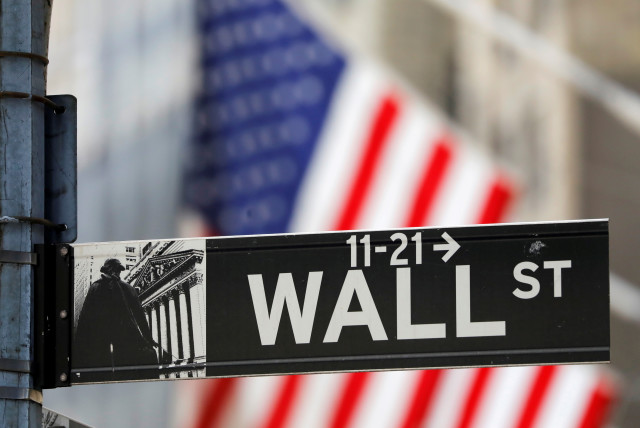  A street sign for Wall Street is seen outside the New York Stock Exchange (NYSE) in New York City, New York, US, July 19, 2021. (credit: REUTERS/ANDREW KELLY/FILE PHOTO)