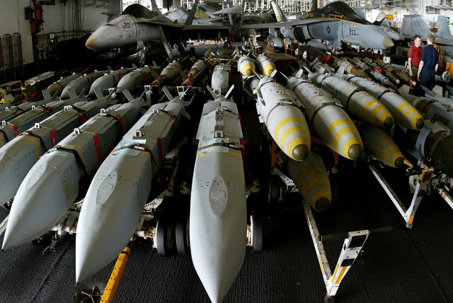 Aviation ordonancemen stand next to JSOW (Joint Standoff Weapon) (left) and JDAM satellite guided bombs (right) aboard the USS Kitty Hawk aircraft carrier in the northern Gulf April 9, 2003 (credit: YVES HERMAN/REUTERS)