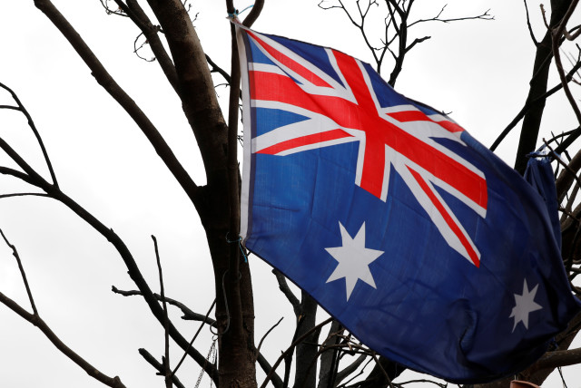  An Australian flag is seen hung in a tree burnt by bushfire on the property of farmer Jeff McCole in Buchan, Victoria, Australia (credit: REUTERS/ANDREW KELLY)