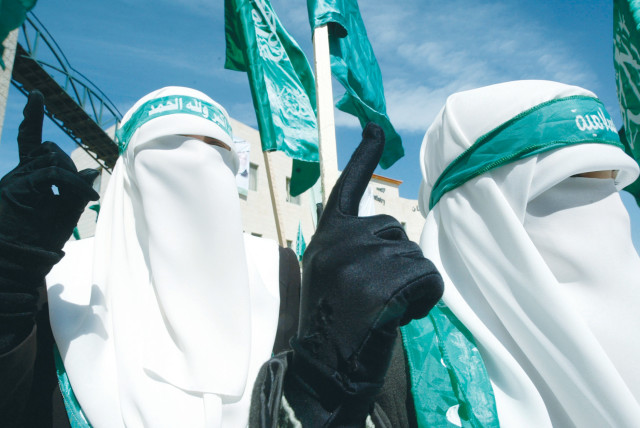  Hamas supporters wearing veils and gloves take part in an anti-Israel rally in Jenin.  (photo credit: MOHAMAD TOROKMAN/REUTERS)