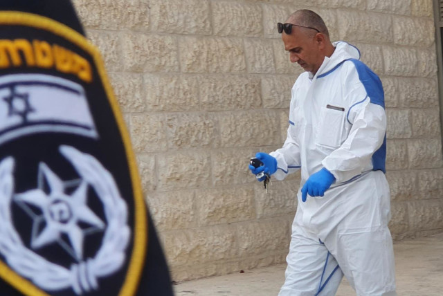  An Israel Police forensic investigator is seen at the scene of the crime in Beit Shemesh on October 30, 2021 (credit: ISRAEL POLICE)