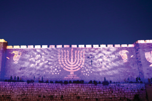  Images of Hanukkah are splashed on the walls of Jerusalem’s Old City. (credit: MARC ISRAEL SELLEM)