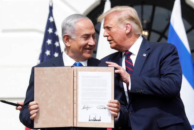  Israel's Prime Minister Benjamin Netanyahu stands with US President Donald Trump after signing the Abraham Accords, normalizing relations between Israel and some of its Middle East neighbors, in a strategic realignment of Middle Eastern countries against Iran, on the South Lawn of the White House i (credit: REUTERS/TOM BRENNER)