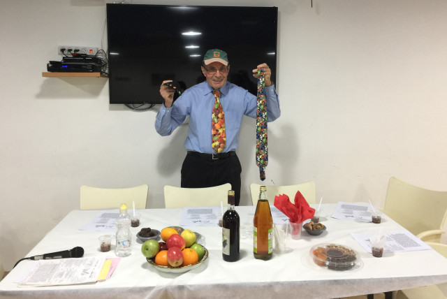  Dr. Richard H. Schwartz prepares for his annual Tu Bishvat seder. (credit: RICHARD SCHWARTZ)