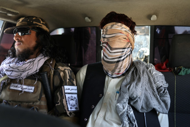  A SUSPECTED ISIS member sits blindfolded in a Taliban Special Forces car in Kabul, Afghanistan, Sept. 5. (credit: WANA VIA REUTERS)