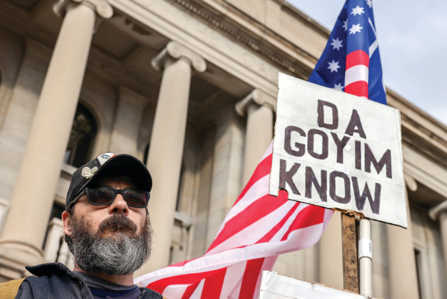  A WHITE SUPREMACIST protester holds an antisemitic sign outside the Kenosha County Courthouse during jury deliberations in the Kyle Rittenhouse trial, in Kenosha, Wisconsin, last month. (credit: EVELYN HOCKSTEIN/REUTERS)