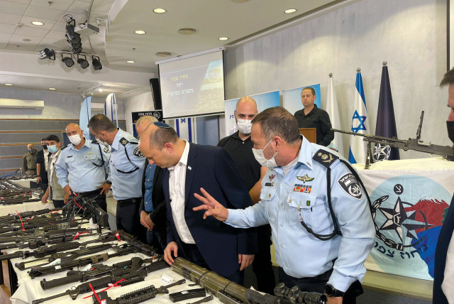  PRIME MINISTER Naftali Bennett and Police commissioner Kobi Shabtai examine rifles caught during Operation Ocean last month. (credit: ISRAEL POLICE)