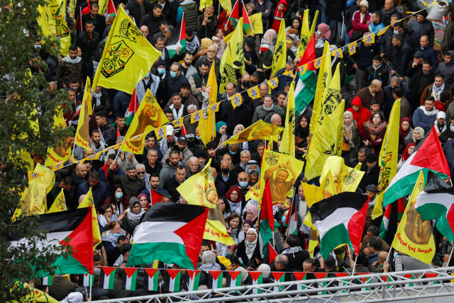  Palestinians attend a rally marking the 57th anniversary of Fatah movement foundation (credit: REUTERS/MOHAMAD TOROKMAN)