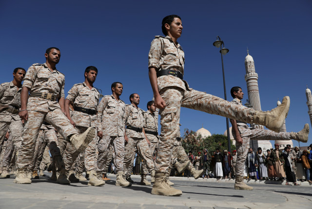 Newly recruited Houthi soldiers march during the funeral of Houthi fighters killed during recent fighting against government forces, in Sanaa, Yemen, December 6, 2021. (credit: REUTERS/KHALED ABDULLAH)