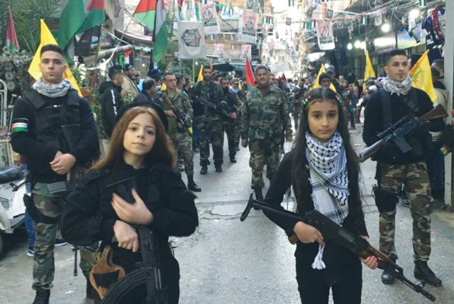  GIRLS WITH automatic rifles lead Fatah’s anniversary parade as seen, according to Palestinian Media Watch, on the official Fatah Facebook page. (credit: PALESTINIAN MEDIA WATCH)