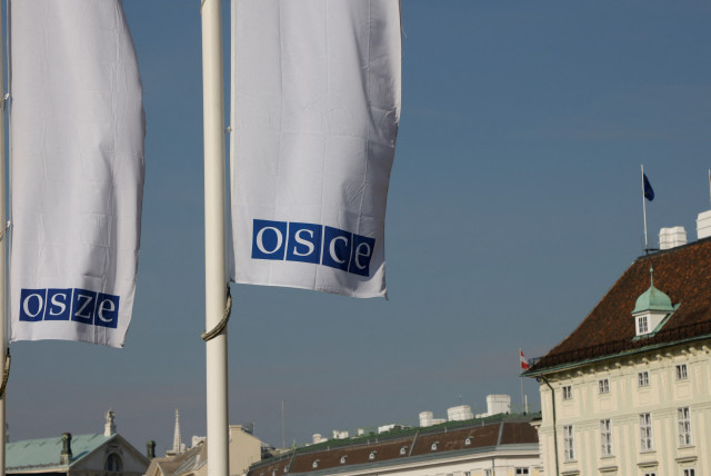  Flags of the Organisation for Security and Cooperation in Europe (OSCE) are pictured outside their headquarters in Vienna, Austria February 15, 2022. (credit: LEONHARD FOEGER / REUTERS)