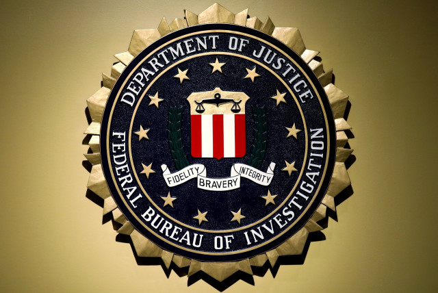  The Federal Bureau of Investigation seal is seen at FBI headquarters before a news conference by FBI Director Christopher Wray on the U.S Justice Department's inspector general's report regarding the actions of the Federal Bureau of Investigation and the 2016 US presidential election in Washington, (credit: REUTERS/YURI GRIPAS)