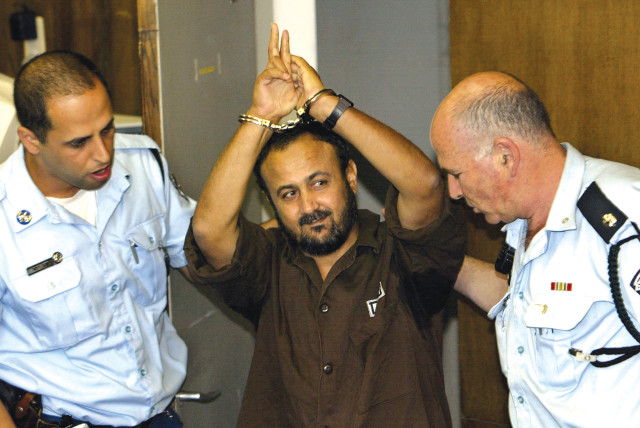  MARWAN BARGHOUTI is brought into court by police for his judgment hearing in May 2004, at which he was convicted on five counts of murder in terrorist attacks. (credit: David Silverman/Reuters)