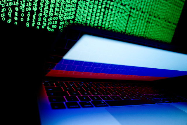  A Russian flag is seen on the laptop screen in front of a computer screen on which cyber code is displayed, in this illustration picture taken March 2, 2018. (credit: REUTERS/KACPER PEMPEL/ILLUSTRATION/FILE PHOTO)