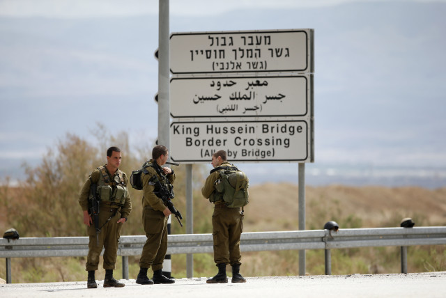  Israeli soldiers stand guard near the entrance to Allenby Bridge, a crossing point between Jordan and the West Bank (credit: REUTERS/Ronen Zvulun)