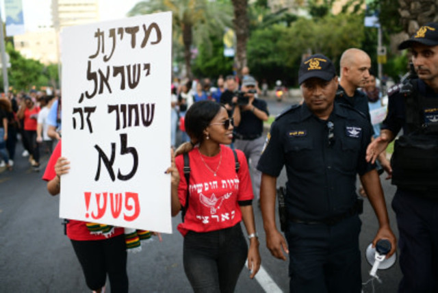 Ethiopian-Israelis and supporters take part in a protest against police violence and discrimination following the death of 19-year-old Ethiopian, Solomon Tekah who was shot and killed in Kiryat Haim by an off-duty police officer, in Tel Aviv, July 8, 2019 (credit: TOMER NEUBERG/FLASH90)