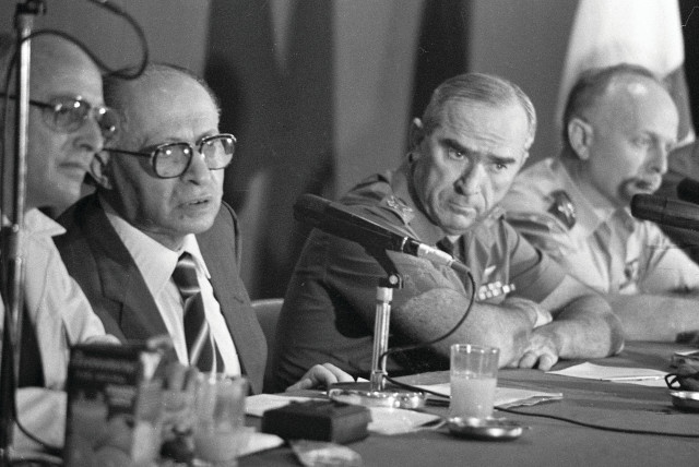  PRIME MINISTER Menachem Begin holds a special press conference to announce the Osirak reactor bombing, June 9, 1981. Also present: Uri Porat, PM media adviser (L) and IDF Chief of Staff Rafael ‘Raful’ Eitan (R).  (photo credit: NATIONAL LIBRARY OF ISRAEL)