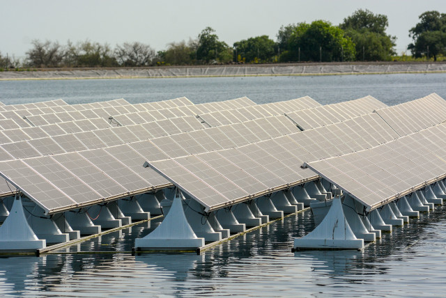 INVESTING IN renewable energies: World's first patented floating solar energy system with adjustable panels, amde by Israeli hi-tech company Xfloat, at the Golan Height's Tzur water reservoir, April 10. (credit: MICHAL GILADI/FLASH90)
