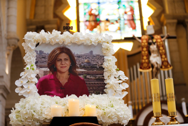  A portrait of Al Jazeera journalist Shireen Abu Akleh, who was killed during an Israeli raid, is displayed during a special mass in her memory in the Church of the Nativity in Bethlehem, in the West Bank, May 16, 2022. (credit: MUSSA QAWASMA/REUTERS)
