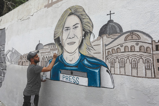  A PALESTINIAN MAN draws a mural of Al Jazeera correspondent Shireen Abu Akleh in Khan Yunis, Gaza Strip. (credit: ABED RAHIM KHATIB/FLASH90)