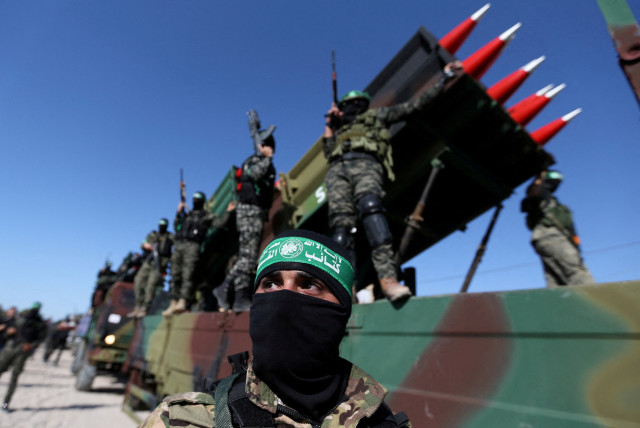  Palestinian Hamas terrorists attend an anti-Israel rally in Khan Younis, in the southern Gaza Strip May 27, 2021 (photo credit: REUTERS/IBRAHEEM ABU MUSTAFA)