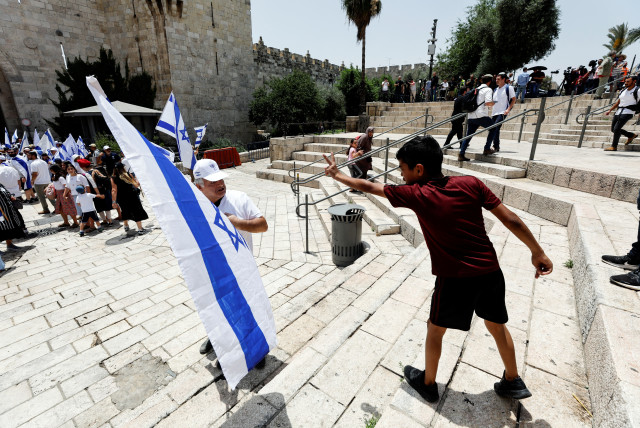  A Palestinian boy and an Israeli man argue near Damascus gate to Jerusalem's Old City, on Jerusalem Day, May 29, 2022. (credit: AMMAR AWAD/REUTERS)