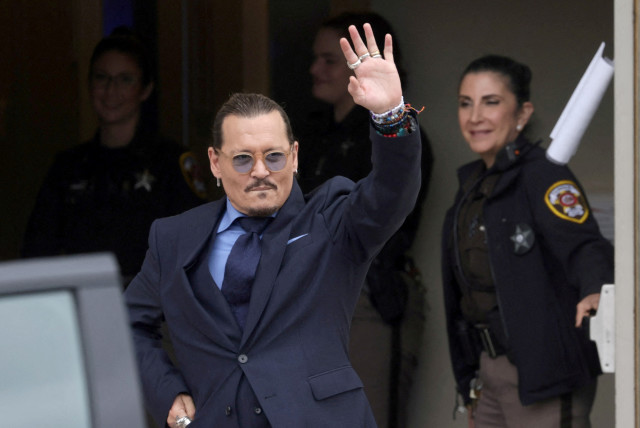  Actor Johnny Depp gestures as he leaves the Fairfax County Circuit Courthouse following his defamation trial against his ex-wife Amber Heard, in Fairfax, Virginia, U.S., May 27, 2022.  (credit: REUTERS/Evelyn Hockstein/File Photo)