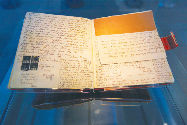  ANNE FRANK’S diary is on display at the Anne Frank House in Amsterdam. Anne told a friend that the moment she learned she no longer had a family she interpreted this as the end of the world.  (credit: REUTERS/CRIS TOALA OLIVARES)