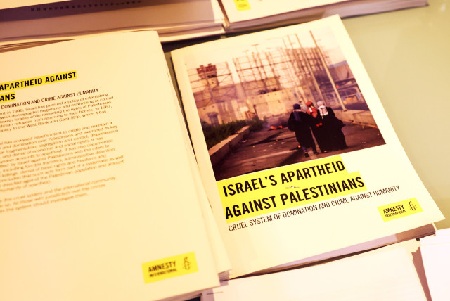  Copies of Amnesty International's report named ''Israel's Apartheid Against Palestinians: Cruel System of Domination and Crime Against Humanity'' are seen at a press conference at the St George Hotel, in East Jerusalem, February 1, 2022. (credit: RONEN ZVULUN/REUTERS)