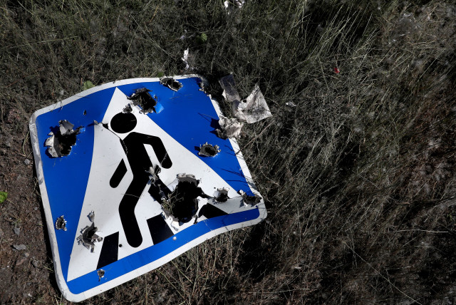  A road sign damaged by cluster munition is seen following a military strike, amid Russia's attack on Ukraine, on the outskirts of Kharkiv, Ukraine June 10, 2022.  (credit: REUTERS/IVAN ALVARADO)