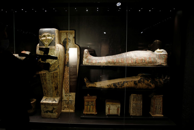  A cameraman films the only known example of a pregnant Egyptian mummy, displayed at an exhibition in National Museum in Warsaw, Poland May 4, 2021 (credit: REUTERS/KACPER PEMPEL)